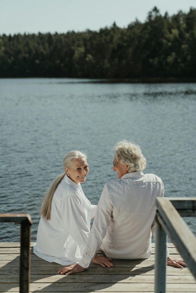 old wealthy couple relaxing by the lake